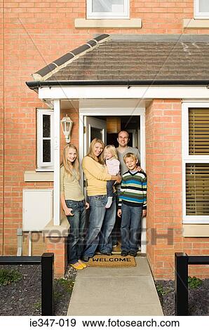 Family at front door of house View Large Photo Image Stock Photo - Family at front door of house. Fotosearch