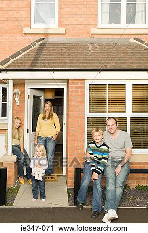 Stock Image - Family outside house. Fotosearch