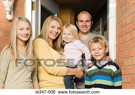 Family outside house View Large Photo Image Stock Photograph - Family outside house. Fotosearch