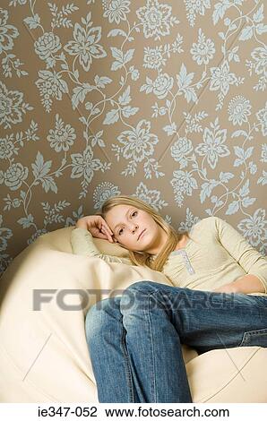 Girl sitting on beanbag View Large Photo Image Stock Image - Girl sitting on beanbag. Fotosearch
