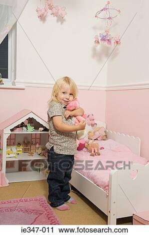 Little girl in her room View Large Photo Image Stock Image - Little girl in her room. Fotosearch