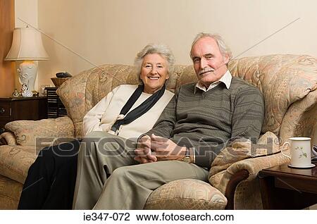 Stock Image - Senior couple on sofa. Fotosearch
