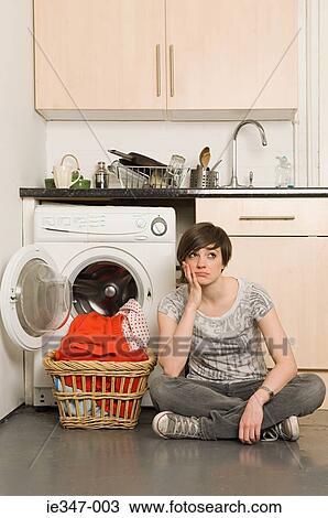 Sullen young woman and laundry View Large Photo Image Stock Image - Sullen young woman and laundry. Fotosearch