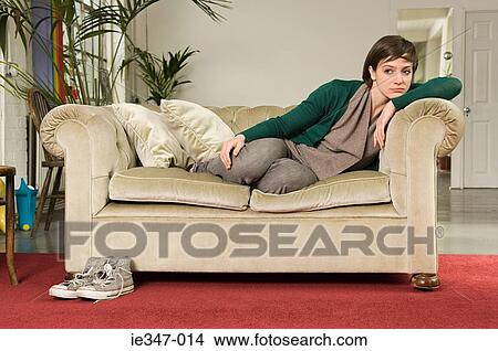Sullen young woman on sofa View Large Photo Image Picture - Sullen young woman on sofa. Fotosearch
