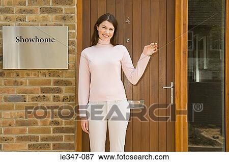 Woman outside show home View Large Photo Image Stock Photo - Woman outside show home. Fotosearch