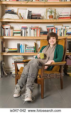 Young woman at home View Large Photo Image Stock Image - Young woman at home. Fotosearch