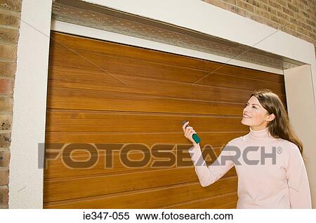 Stock Photography - Young woman by garage. Fotosearch