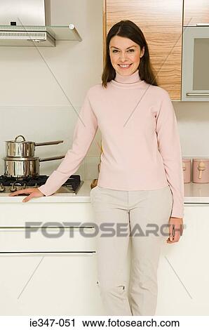 Young woman in kitchen View Large Photo Image Stock Image - Young woman in kitchen. Fotosearch