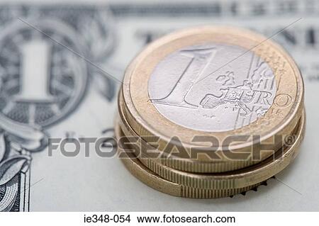Euro coins on dollar bill View Large Photo Image Picture - Euro coins on dollar bill. Fotosearch