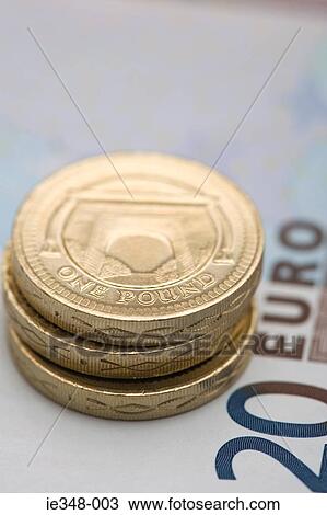 Pound coins on euro note View Large Photo Image Stock Image - Pound coins on euro note. Fotosearch