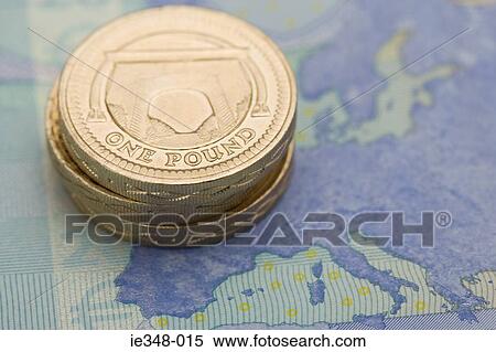Stock Photography - Pound coins on euro note. Fotosearch