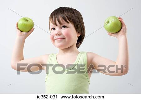 Stock Image - Boy holding apples. Fotosearch