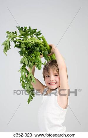 Boy holding celery View Large Photo Image Stock Image - Boy holding celery. Fotosearch