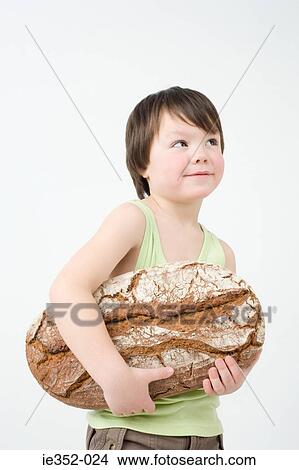 Picture - Boy holding loaf of bread. Fotosearch