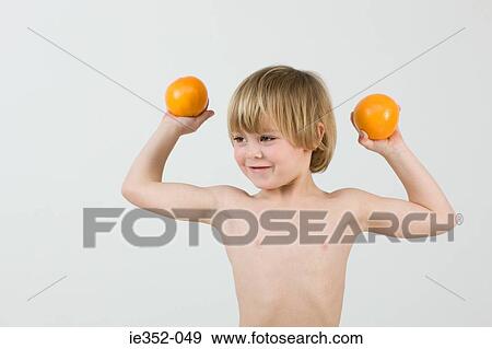 Boy holding oranges View Large Photo Image Stock Photo - Boy holding oranges. Fotosearch