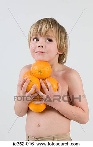 Boy holding oranges View Large Photo Image Stock Photograph - Boy holding oranges. Fotosearch