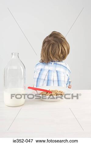 Boy turning back on breakfast View Large Photo Image Stock Photo - Boy turning back on breakfast. Fotosearch