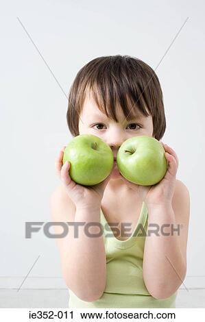 Boy with two apples View Large Photo Image Stock Image - Boy with two apples. Fotosearch