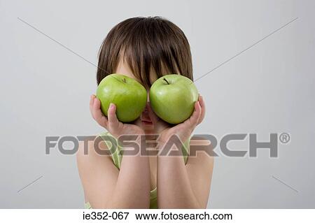 Stock Photo - Child holding two apples. Fotosearch