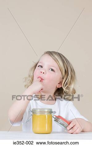 Girl eating lemon curd View Large Photo Image Stock Image - Girl eating lemon curd. Fotosearch