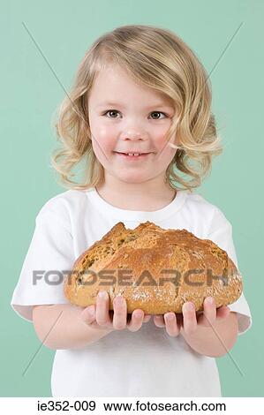 Stock Photo - Girl holding bread. Fotosearch