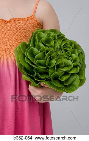 Picture - Girl holding lettuce. Fotosearch