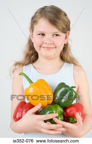 Girl holding peppers View Large Photo Image Stock Photograph - Girl holding peppers. Fotosearch