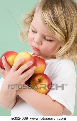 Stock Photo - Girl with apples. Fotosearch