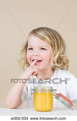 Girl with jar of lemon curd View Large Photo Image Stock Image - Girl with jar of lemon curd. Fotosearch