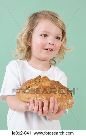 Girl with loaf of bread View Large Photo Image Stock Image - Girl with loaf of bread. Fotosearch