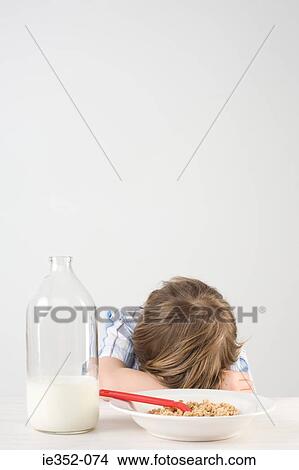 Tired boy at breakfast View Large Photo Image Picture - Tired boy at breakfast. Fotosearch