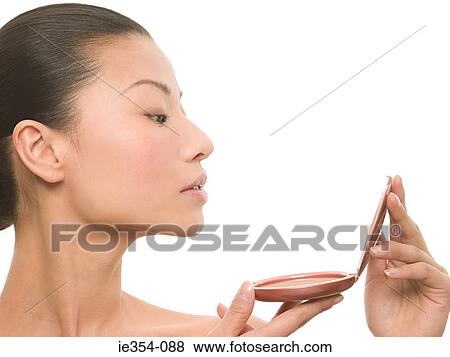 Stock Photo - Woman looking in mirror. Fotosearch
