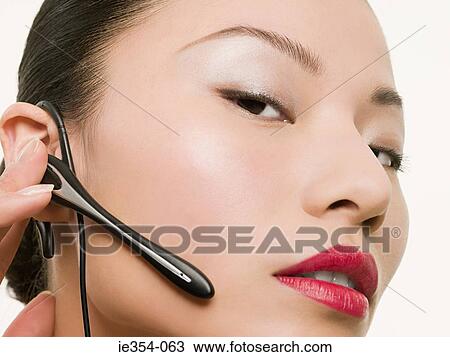 Woman with hands free device View Large Photo Image Stock Image - Woman with hands free device. Fotosearch