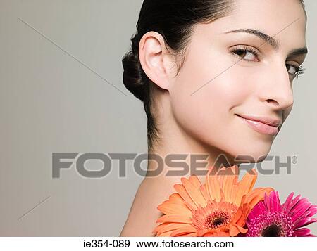 Young woman with flowers View Large Photo Image Stock Photo - Young woman with flowers. Fotosearch