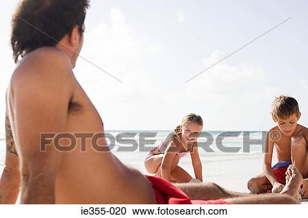 A family on a beach View Large Photo Image Stock Image - A family on a beach. Fotosearch