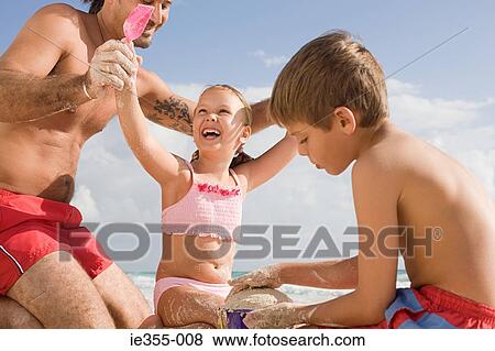Stock Photo - A family on the beach. Fotosearch