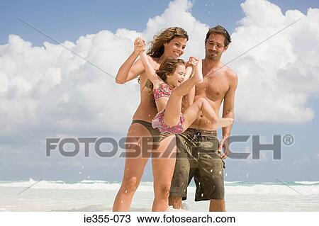 Stock Image - A family playing in the sea. Fotosearch