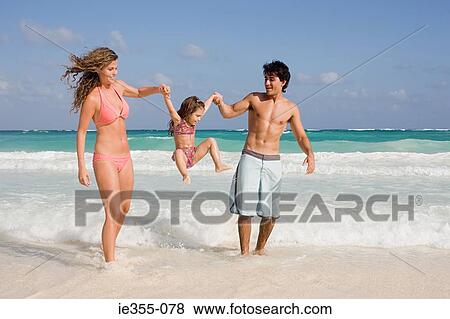 A family playing in the sea View Large Photo Image Stock Photo - A family playing in the sea. Fotosearch