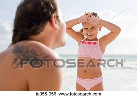 A father and daughter on a beach View Large Photo Image Stock Photograph - A father and daughter on a beach. Fotosearch