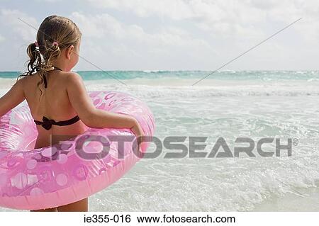 A girl holding a rubber ring View Large Photo Image Stock Photograph - A girl holding a rubber ring. Fotosearch