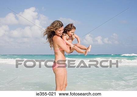 Stock Image - A mother holding her daughter. Fotosearch