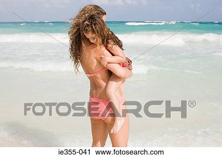 A mother holding her daughter View Large Photo Image Stock Image - A mother holding her daughter. Fotosearch