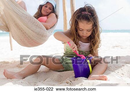 A mother watching her daughter playing View Large Photo Image Stock Image - A mother watching her daughter playing. Fotosearch