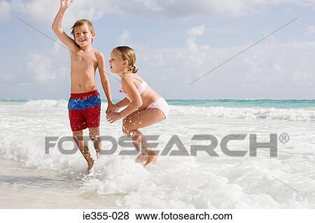 Children playing in the sea View Large Photo Image Stock Photo - Children playing in the sea. Fotosearch