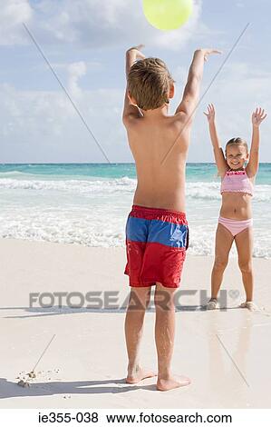 Stock Photo - Children playing with a beach ball. Fotosearch
