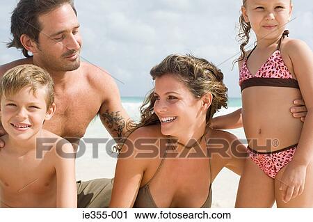 Stock Image - Family on a beach. Fotosearch