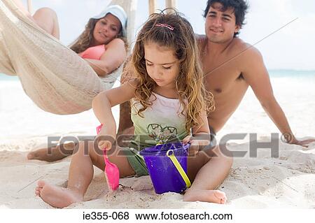Stock Photo - Parents watching their daughter. Fotosearch