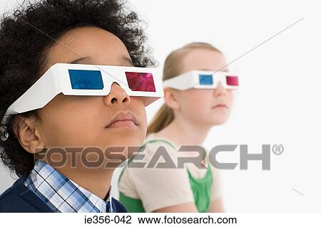 Stock Image - Boy and girl in 3D glasses. Fotosearch