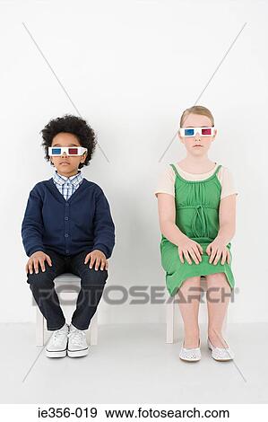 Boy and girl in 3D glasses View Large Photo Image Stock Photo - Boy and girl in 3D glasses. Fotosearch