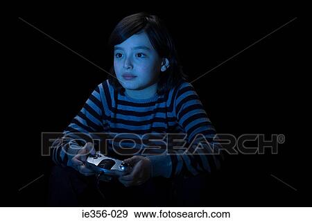 Boy playing video game View Large Photo Image Stock Photo - Boy playing video game. Fotosearch